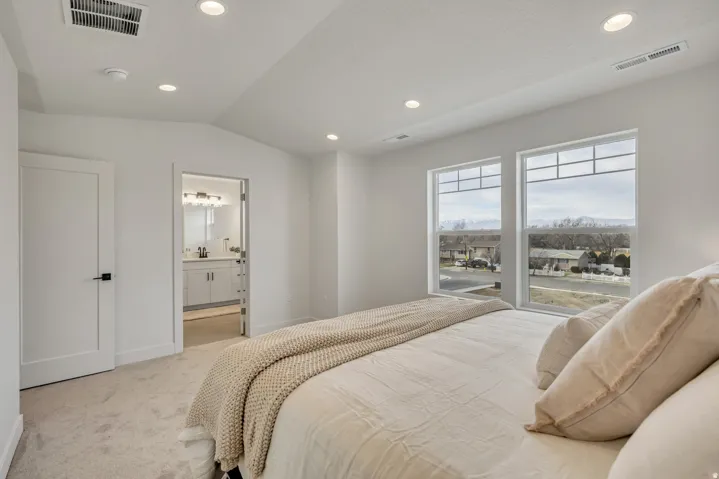 Recessed lighting illuminates the carpeted flooring