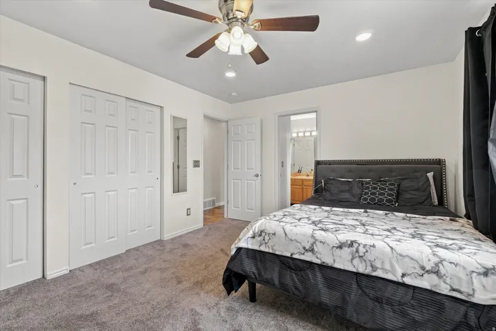 Recessed lighting, ceiling fan, carpeted flooring, and paneled doors