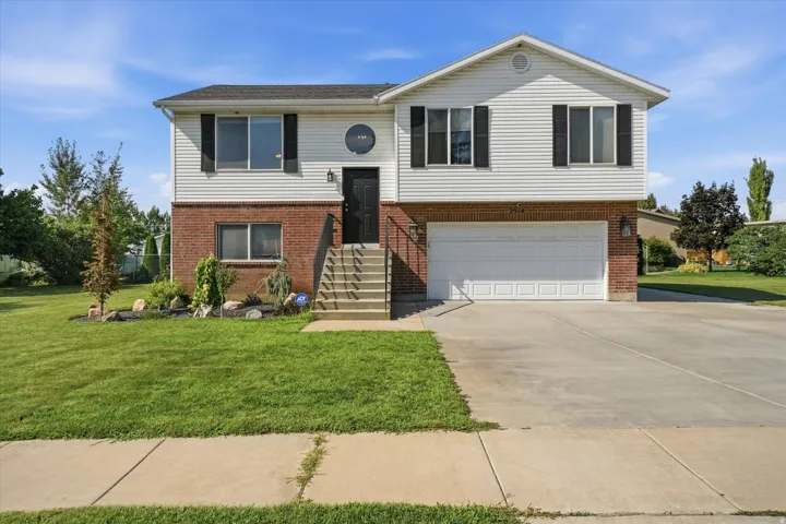 Two-story exterior with white siding and brick accents