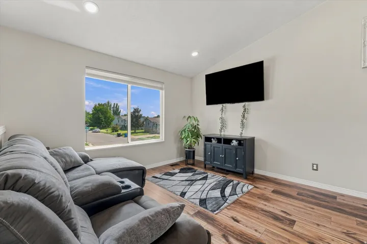 Recessed ceiling lighting, wood-finish flooring, and a large window