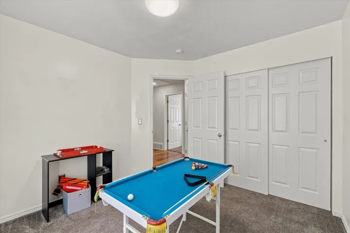 Plush carpeting, interior doors with panel details, recessed lighting, and a neutral wall palette