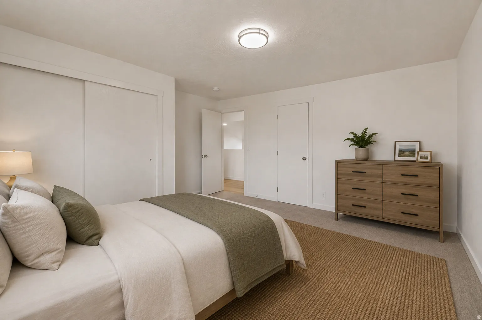 Neutral wall colors, recessed lighting, sliding closet doors, and carpeted flooring