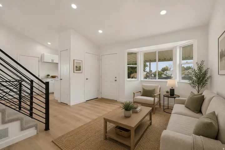 Recessed ceiling lighting, wood-finish flooring, bay window, built-in cabinetry, and a modern stair railing