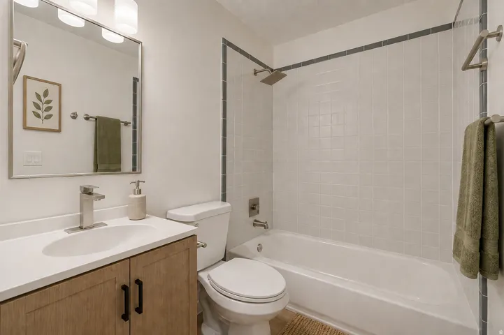 Bathroom featuring a vanity with wood-finish cabinetry, a white countertop, and a rectangular undermount sink