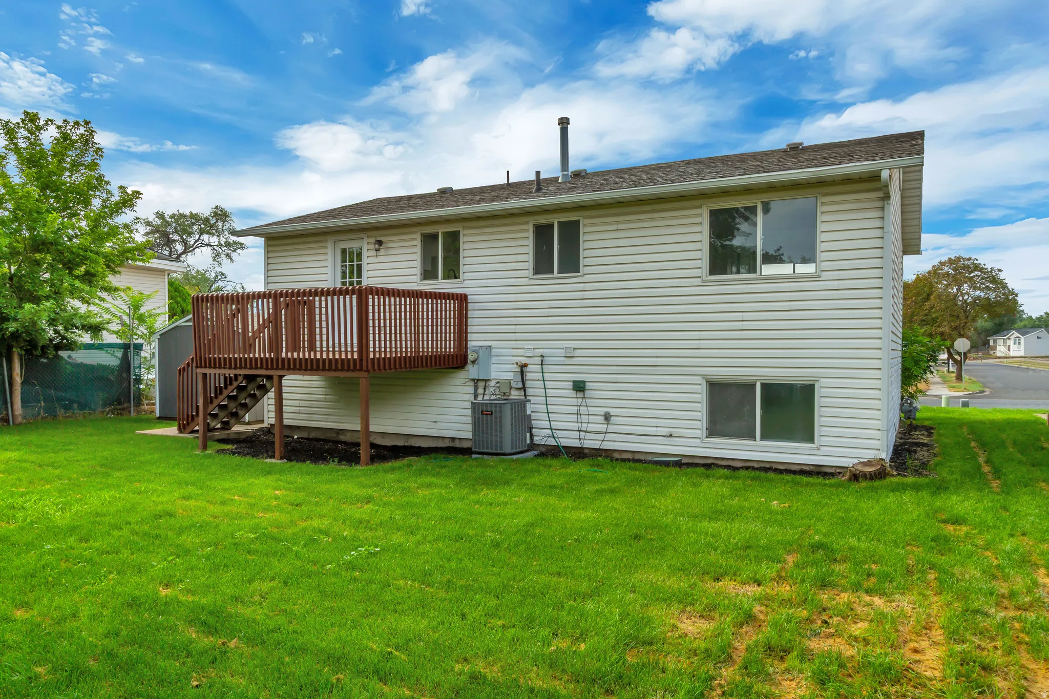 Expansive green lawn surrounds the property