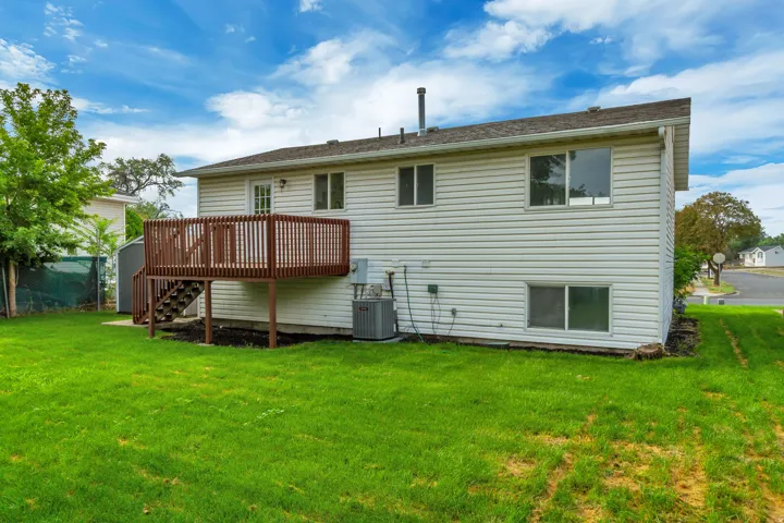 Expansive green lawn surrounds the property