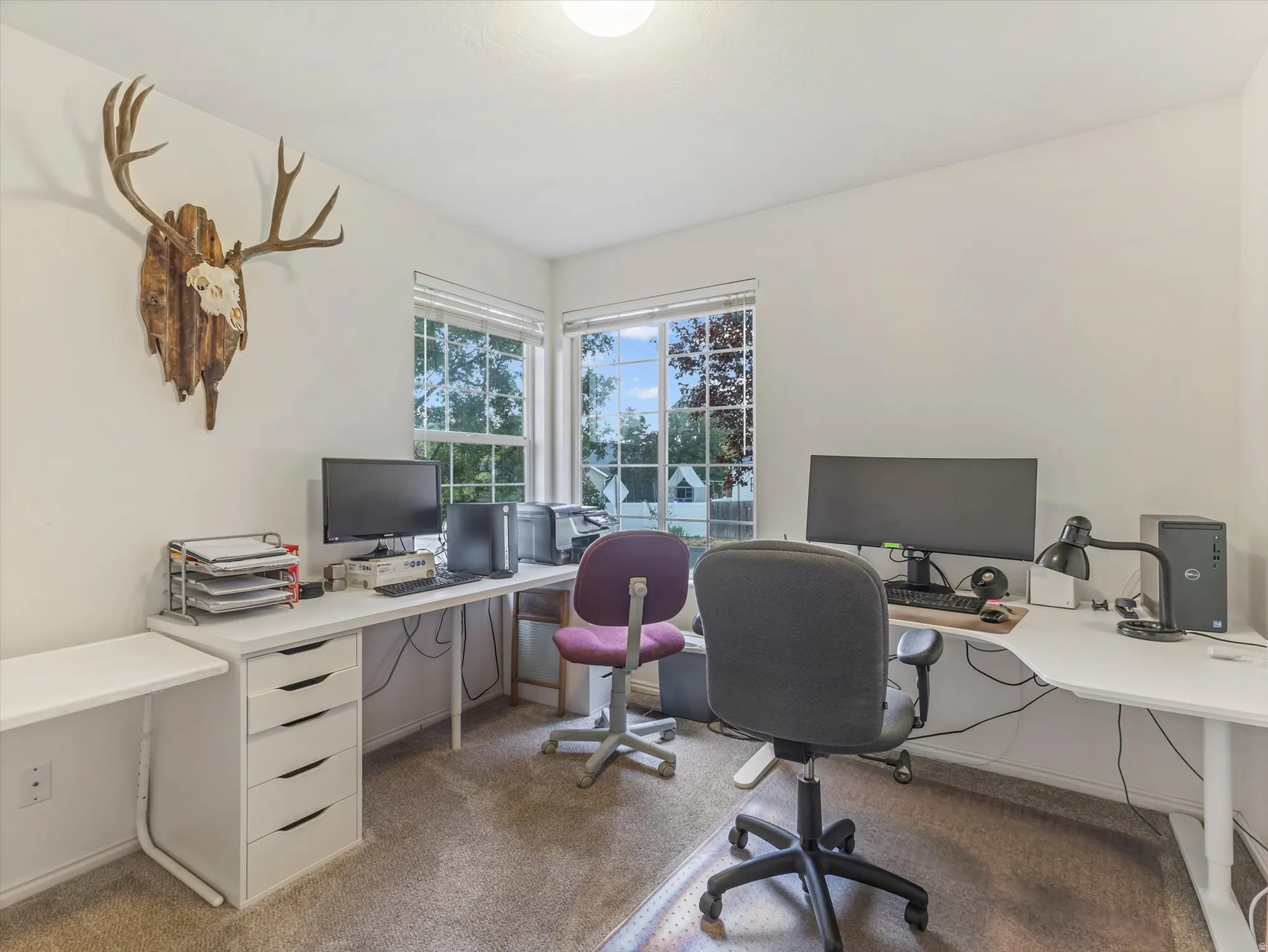 Corner windows with white blinds, carpeted flooring, and recessed ceiling lighting