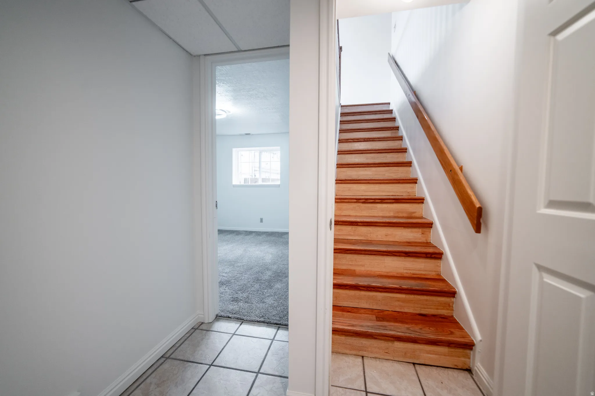 Hardwood staircase with natural wood handrail