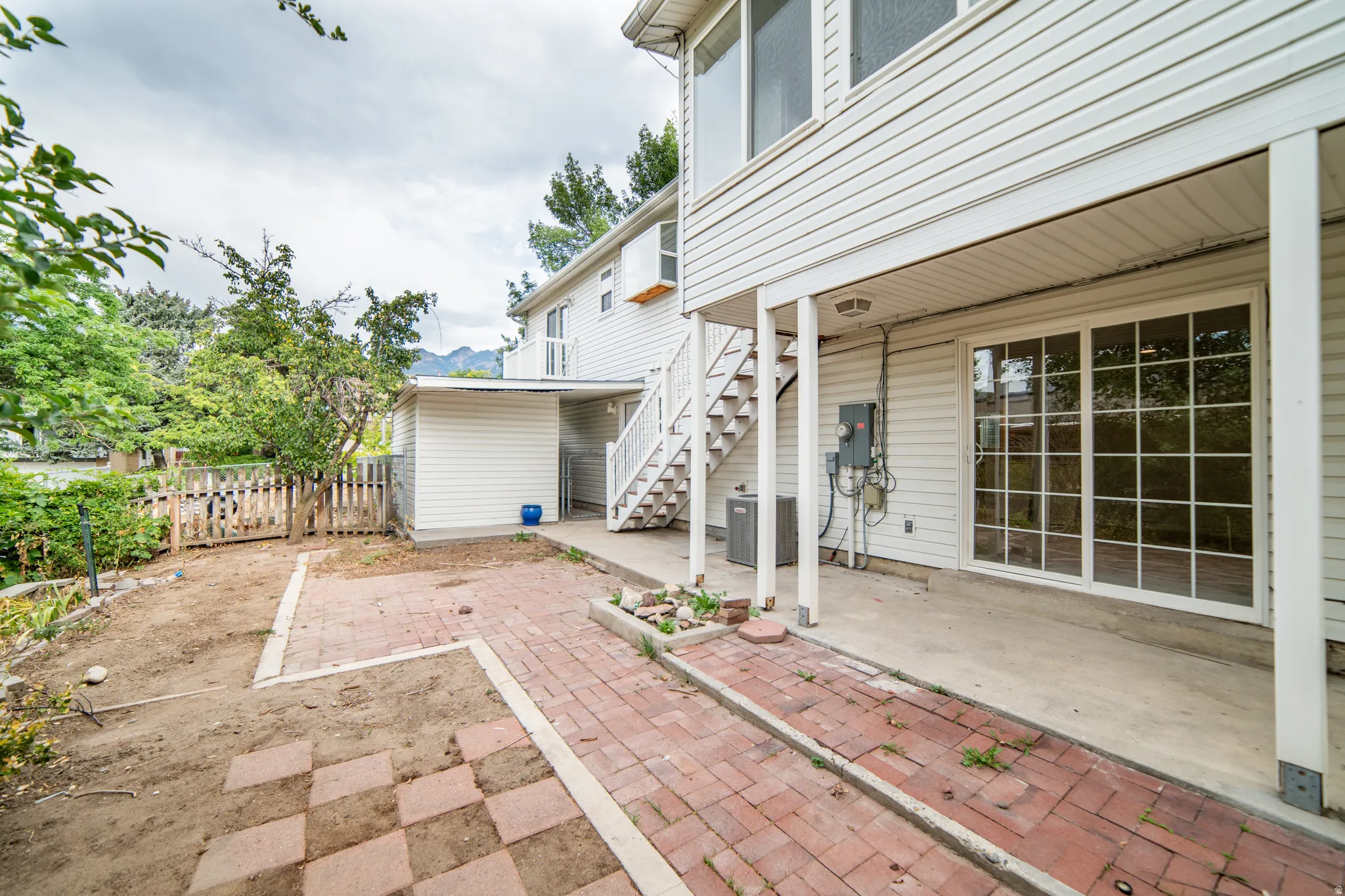 Covered concrete patio with sliding glass door access