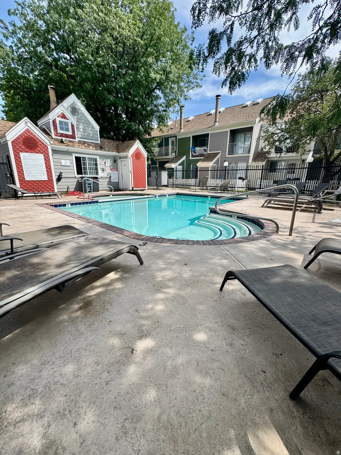 Community swimming pool with integral steps and a dark brick coping