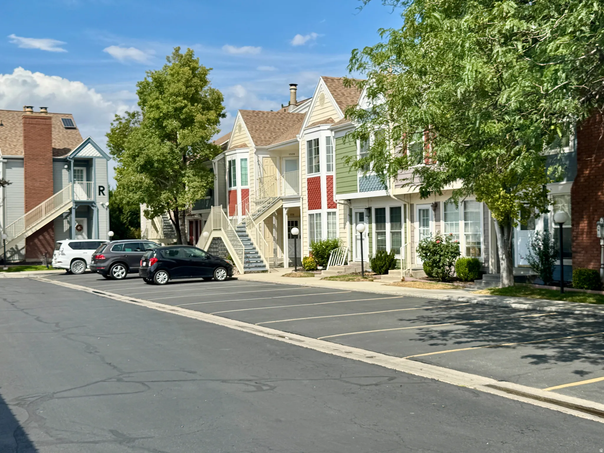 Multi-level residential buildings featuring diverse exterior finishes including siding and brick elements
