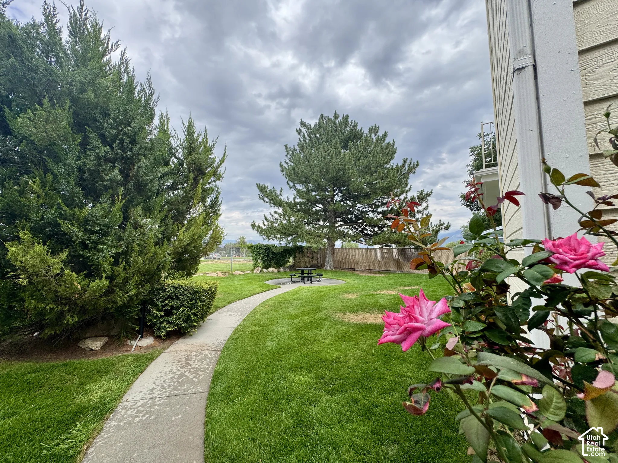 Expansive lawn featuring mature trees and established landscaping