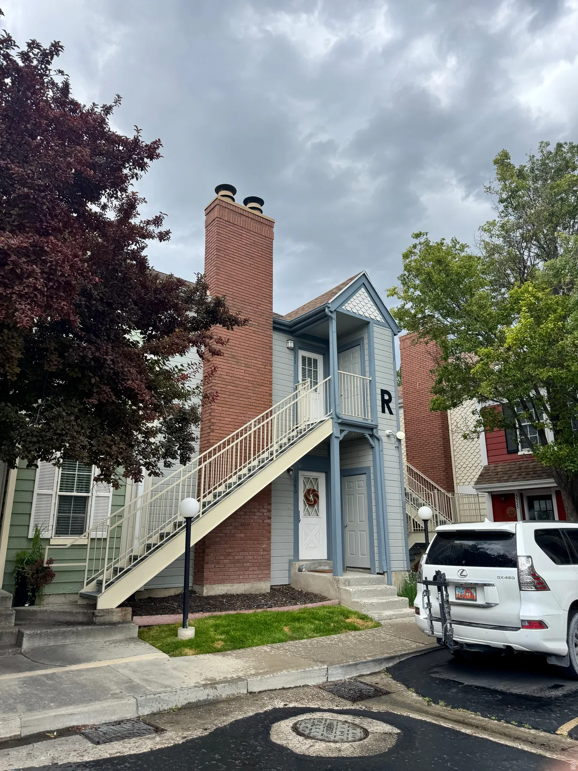 Light blue siding exterior with a prominent brick chimney