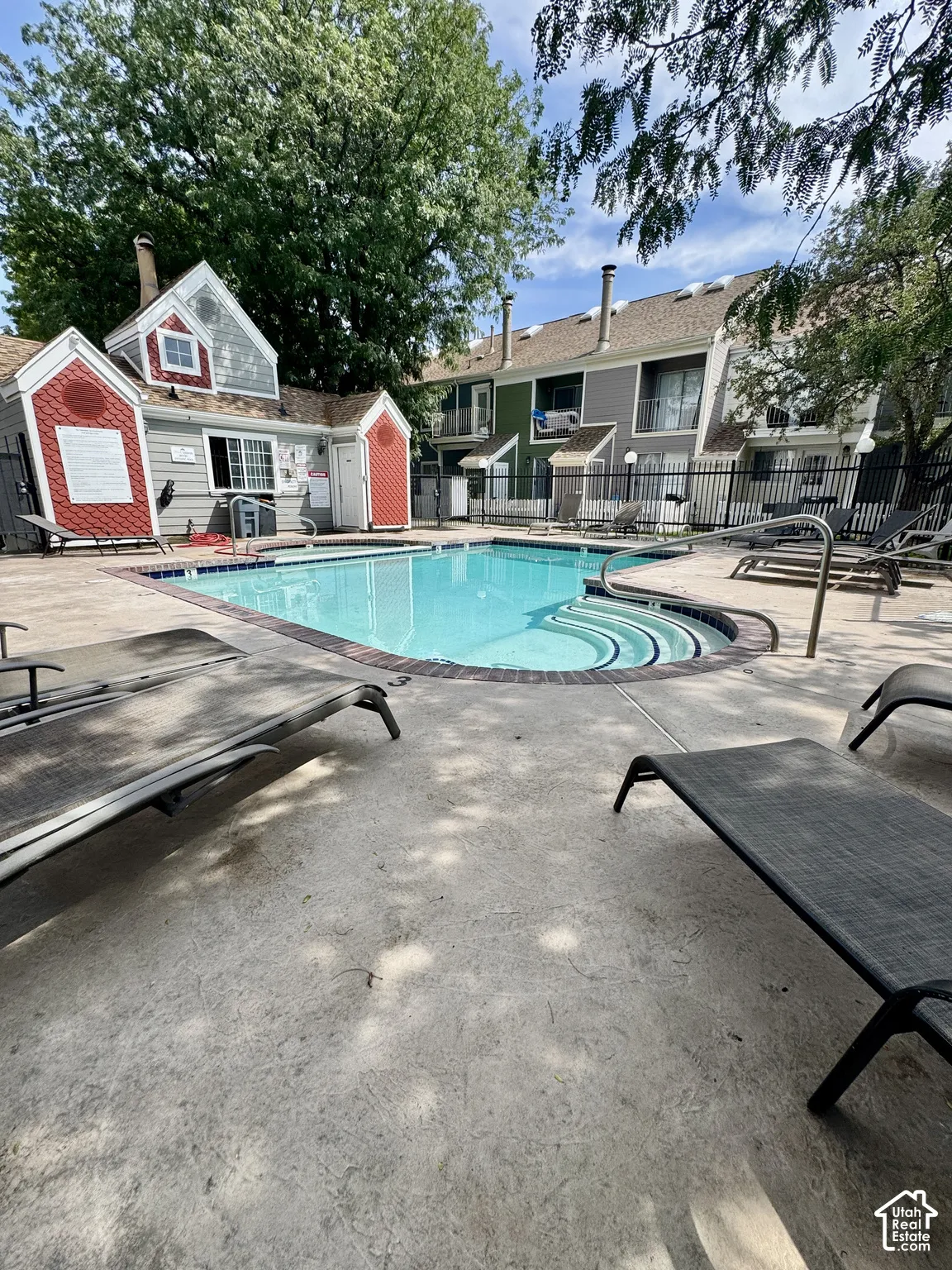 Community swimming pool with integral steps and a dark brick coping