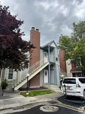 Light blue siding exterior with a prominent brick chimney