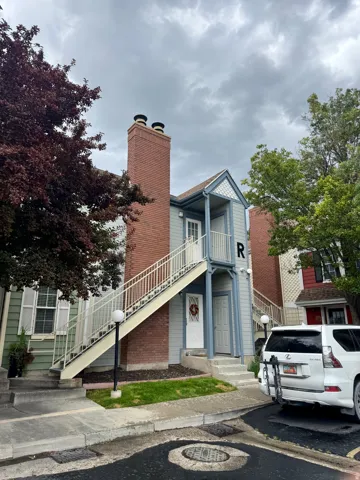 Light blue siding exterior with a prominent brick chimney