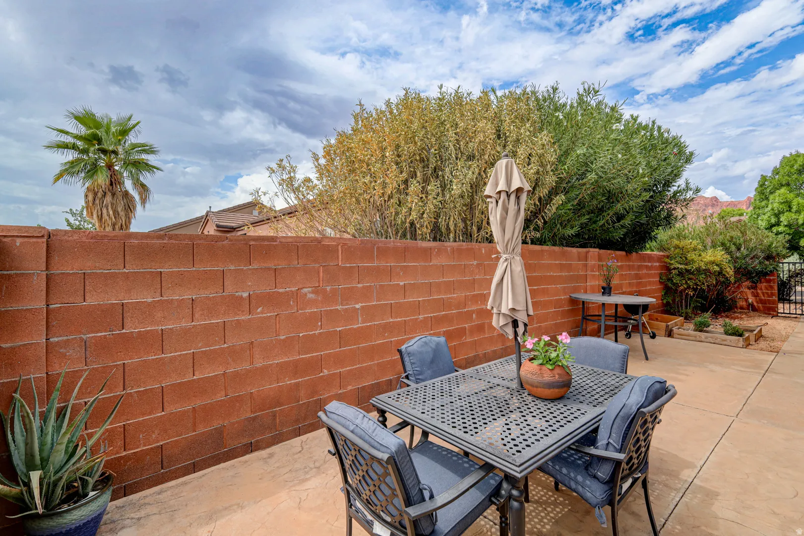 Private patio space with concrete paving and a block wall perimeter