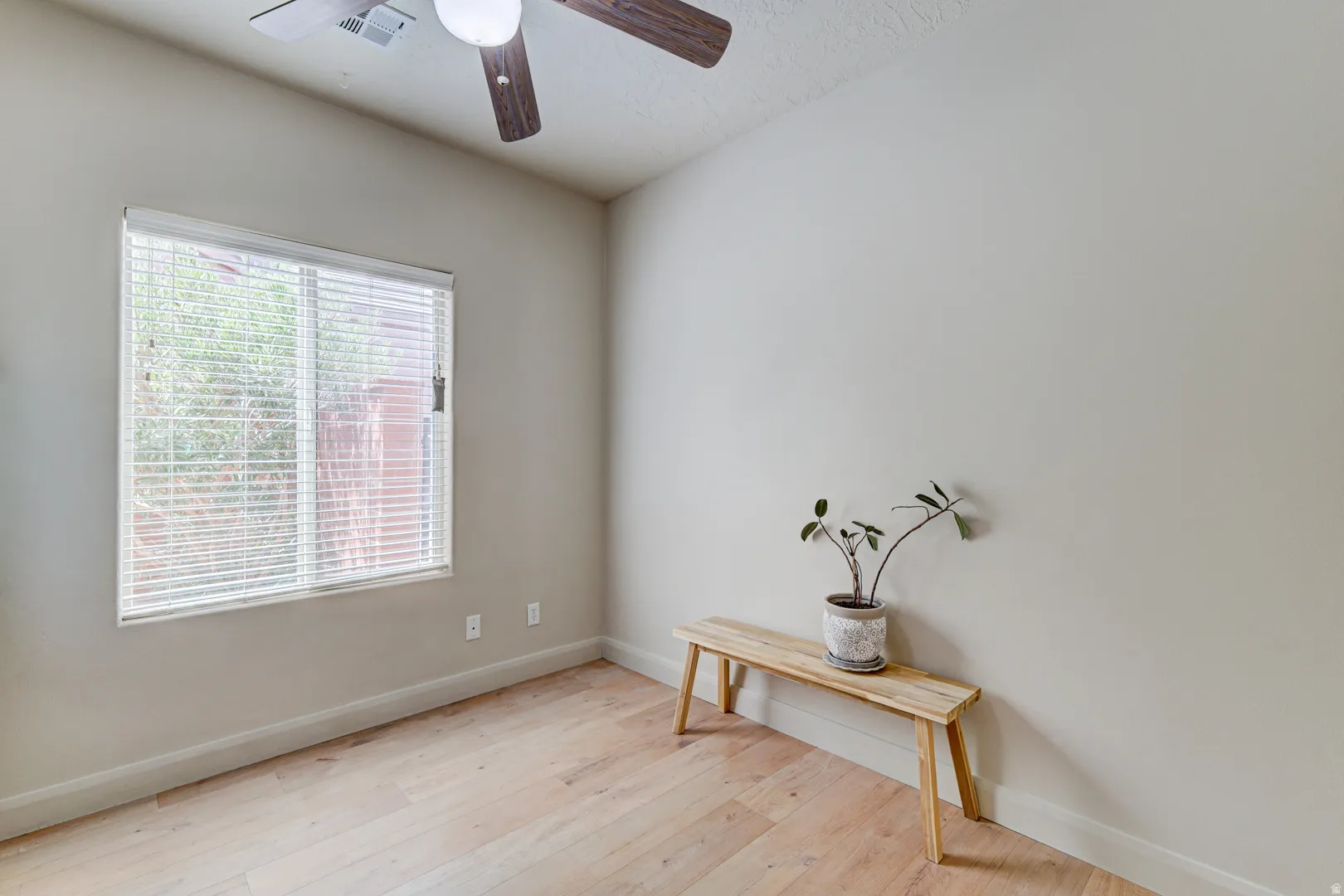 Neutral wall tones complement the wood-finish flooring