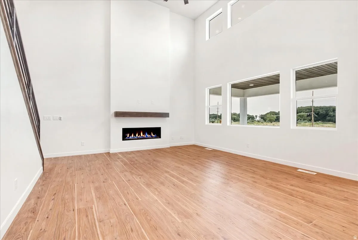Great Room with 2 story windows and ceiling.  LVP looks more neutral in person