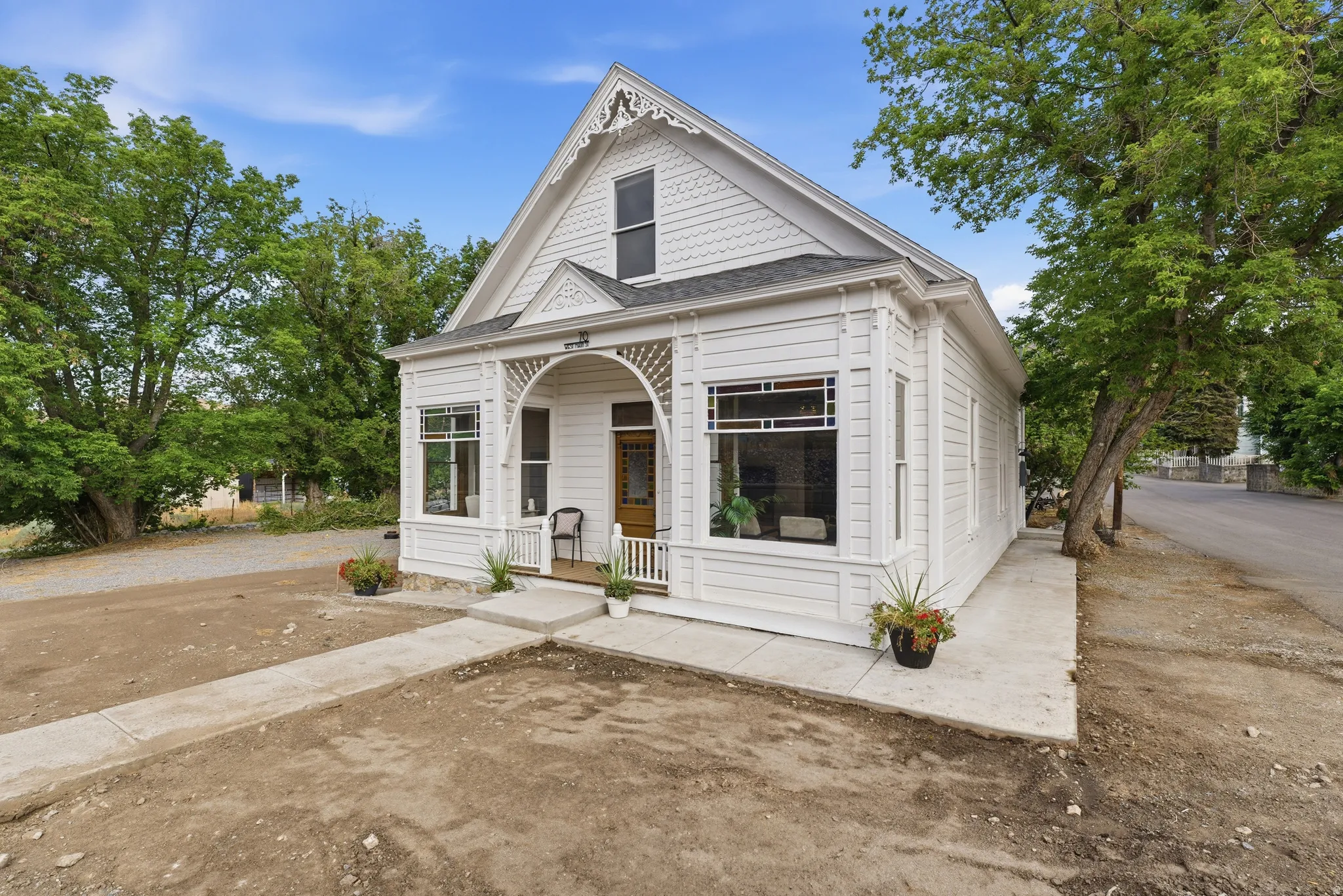 White exterior with decorative gables and shingle siding