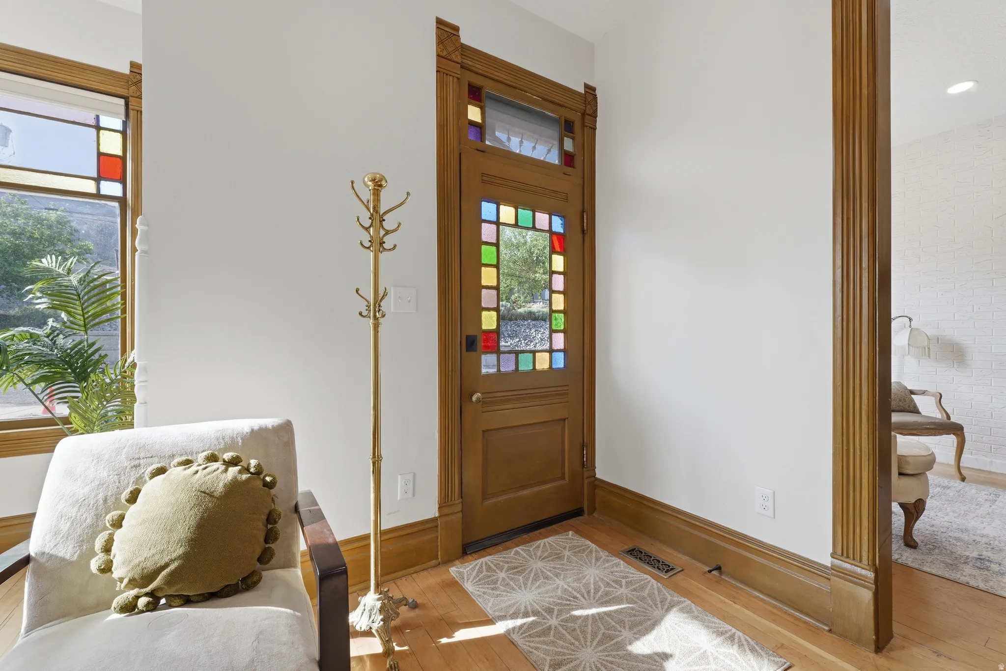 Wood-finish flooring with a decorative door and stained-glass accents