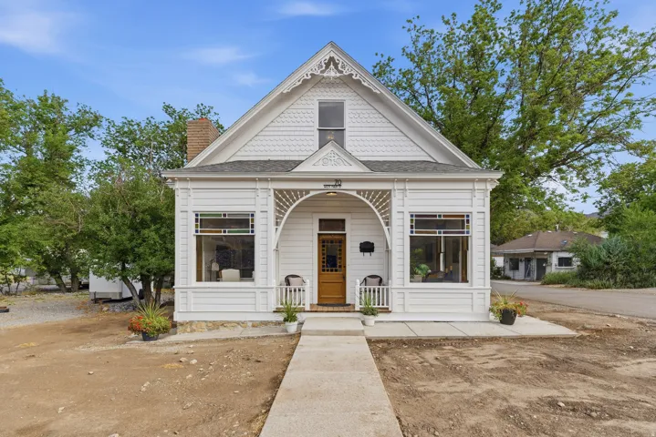 White exterior with decorative gables and shingle accents