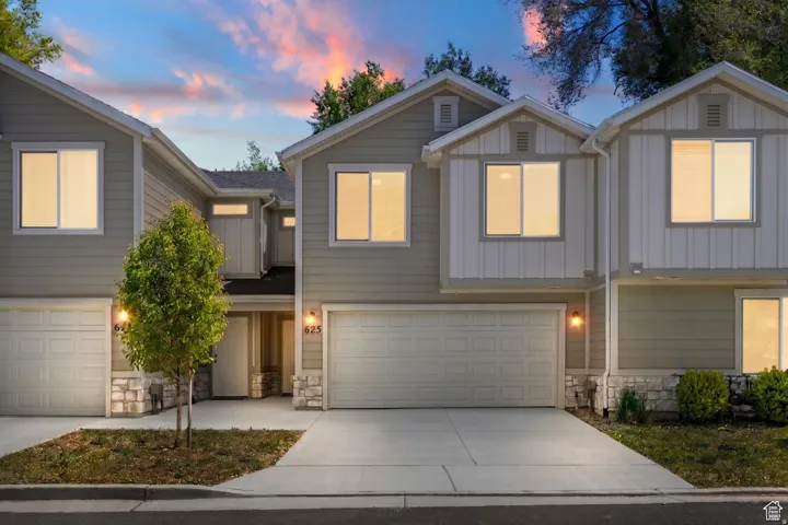 Two-story exterior with light gray siding and white vertical paneling