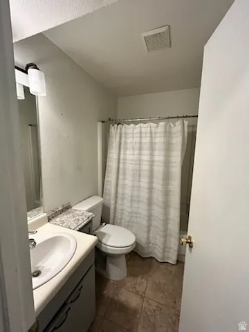Vanity with integrated sink, toilet, and shower with curtain rod