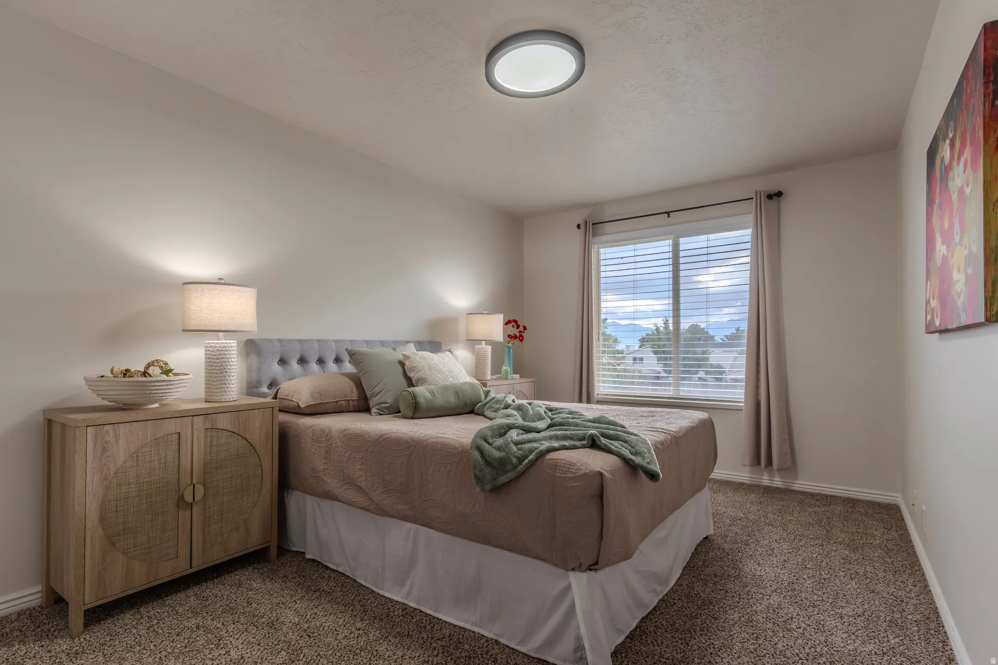Wall-to-wall carpeting and a window with horizontal blinds
