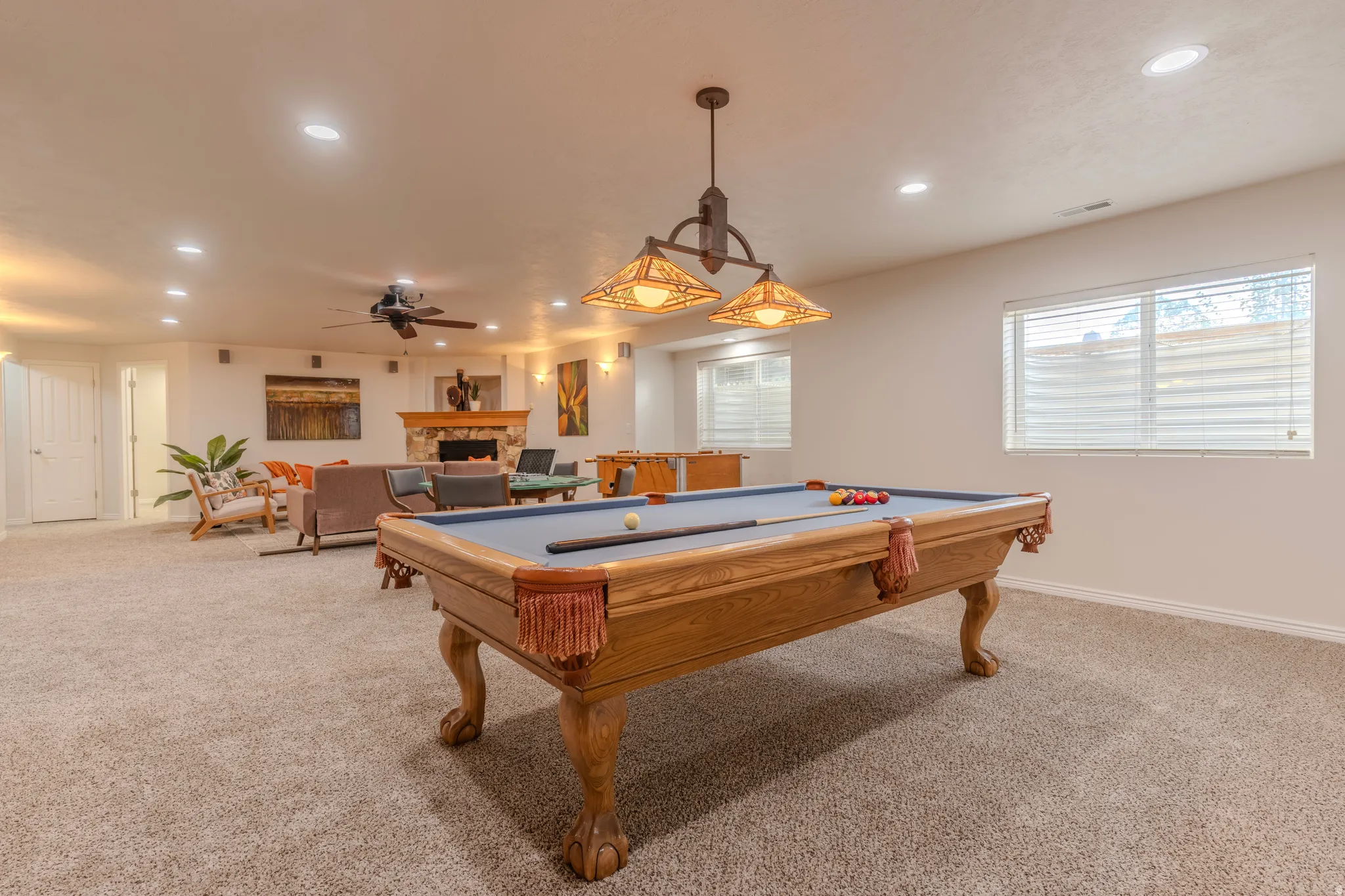 Spacious room with recessed lighting, a ceiling fan, and a built-in fireplace