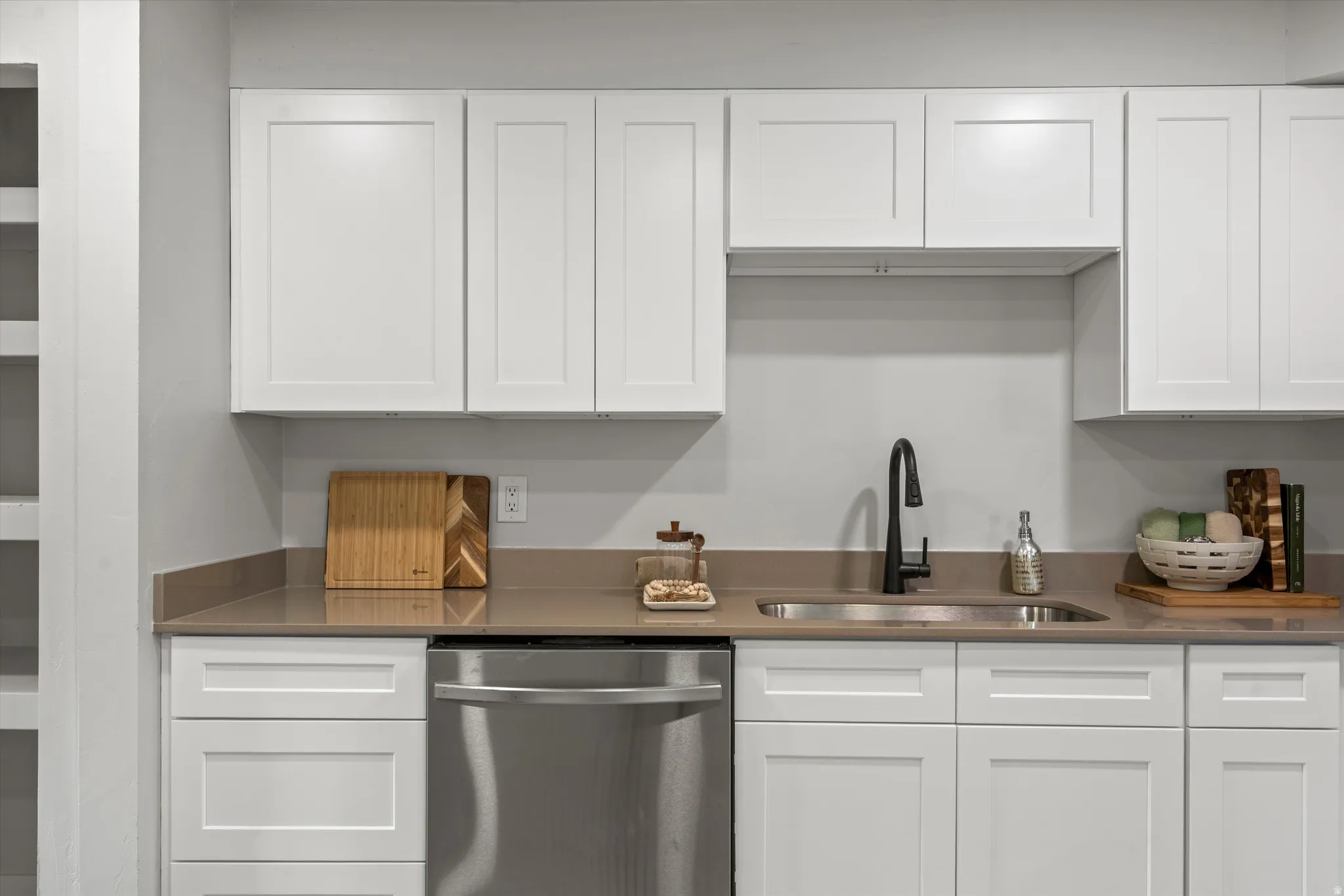 White shaker cabinetry with dark hardware