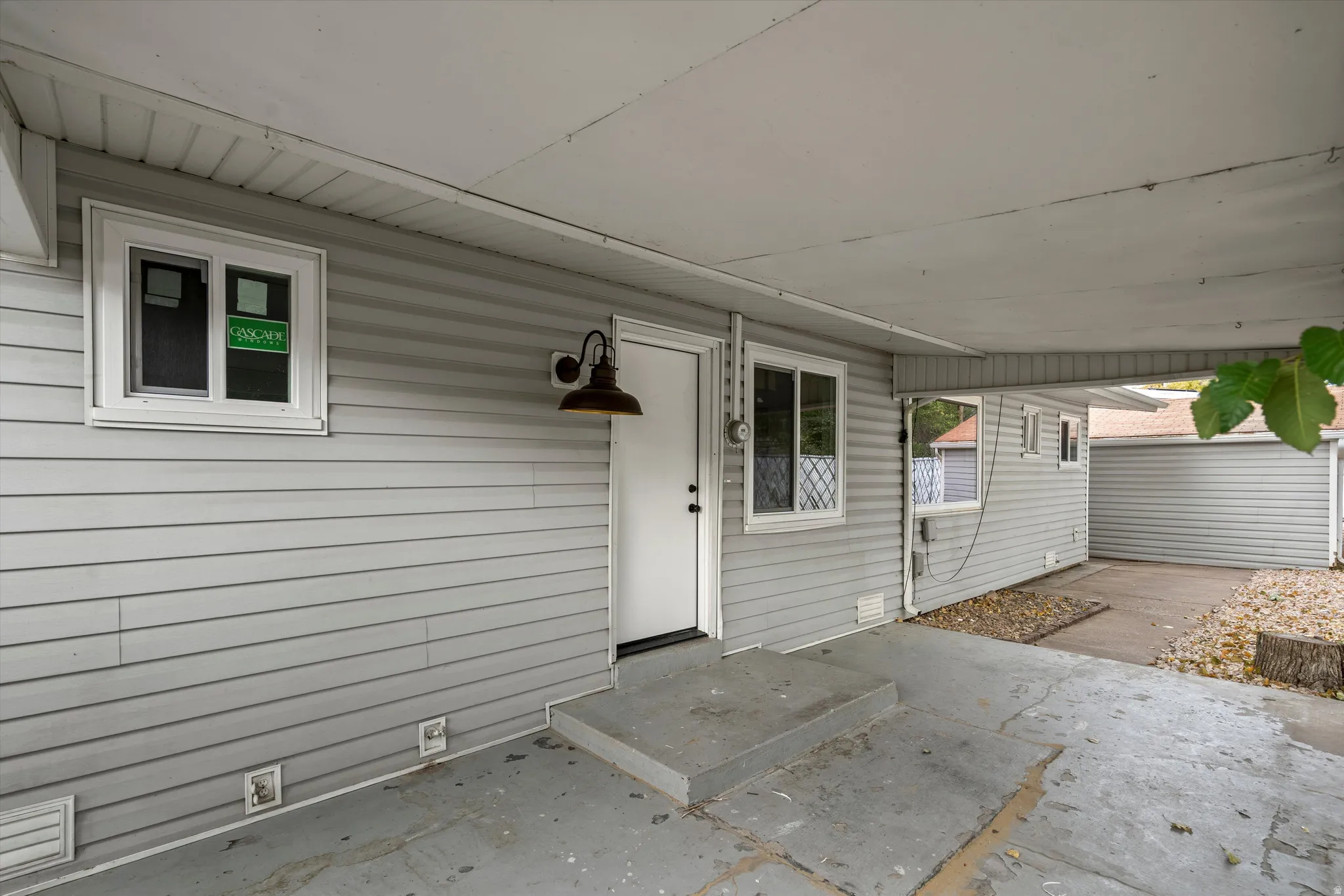 Covered concrete patio with siding exterior