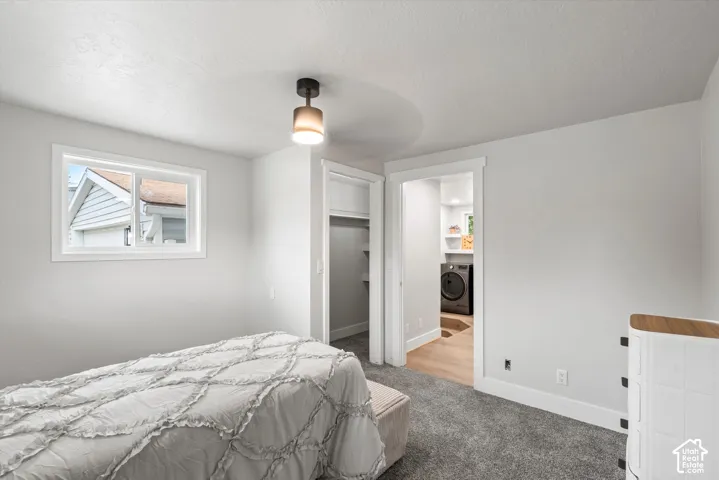 Recessed window with white trim, modern ceiling light fixture, white walls, and gray carpet