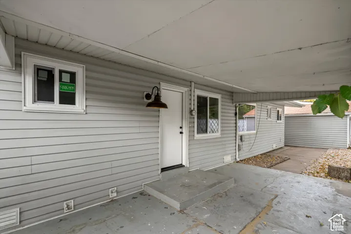 Covered concrete patio with siding exterior