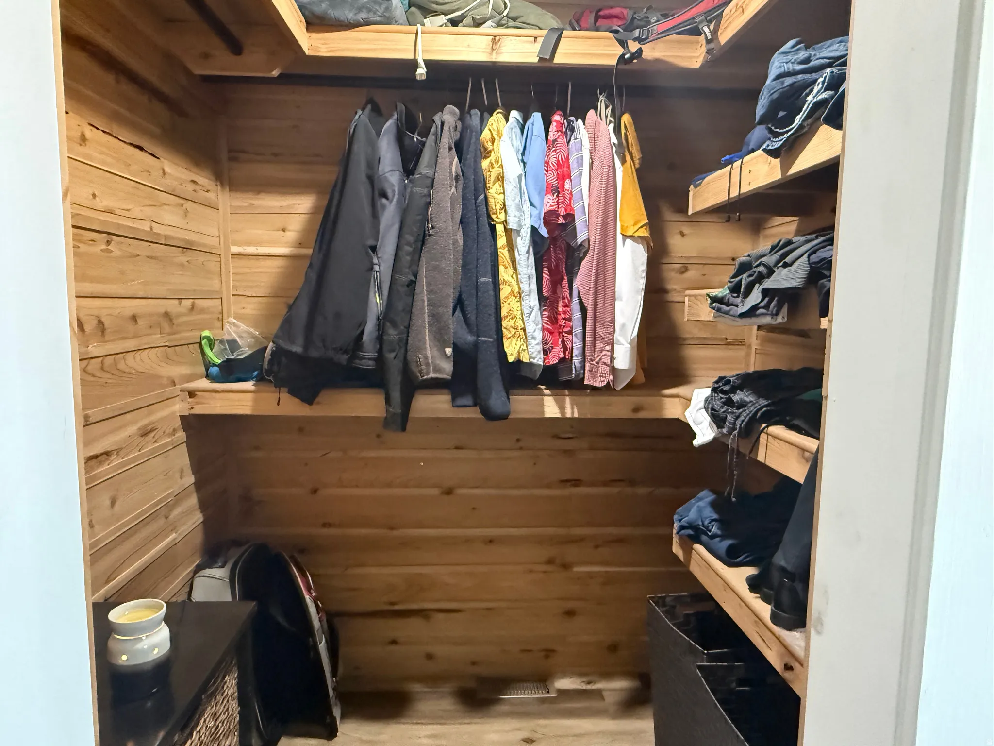 Custom wood-paneled closet featuring built-in shelving and a clothing rod