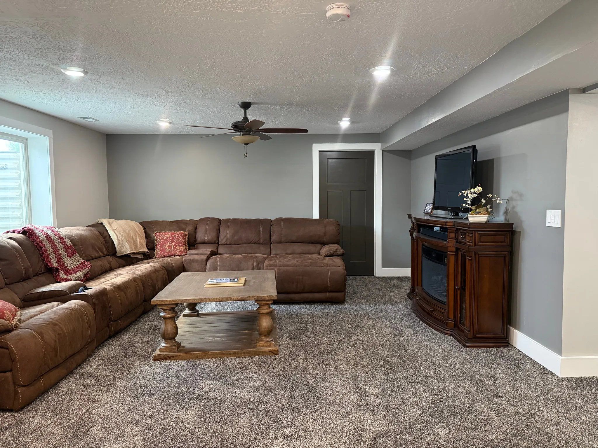 Carpeted living area featuring recessed lighting and a ceiling fan
