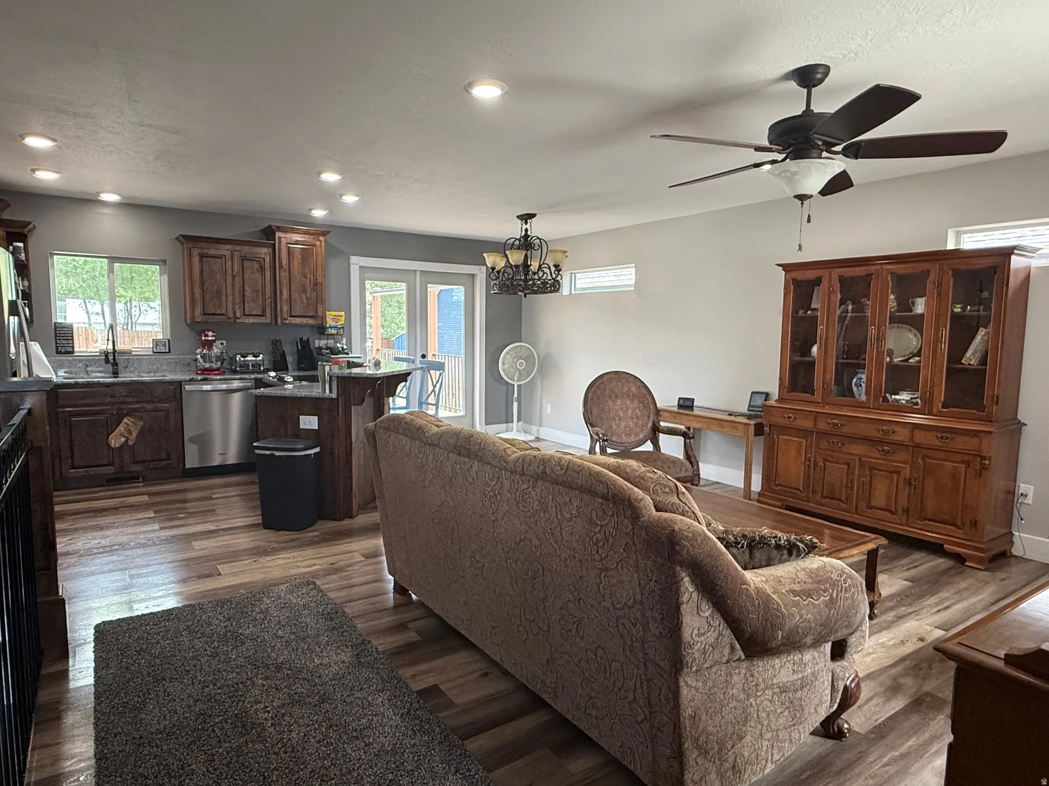 Open-concept living space featuring wood-finish flooring, recessed lighting, and a ceiling fan