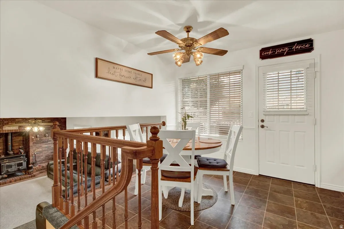 Bright, open-concept space featuring wood-finish flooring, white shutter-style window treatments, and French doors with sidelights providing natural light