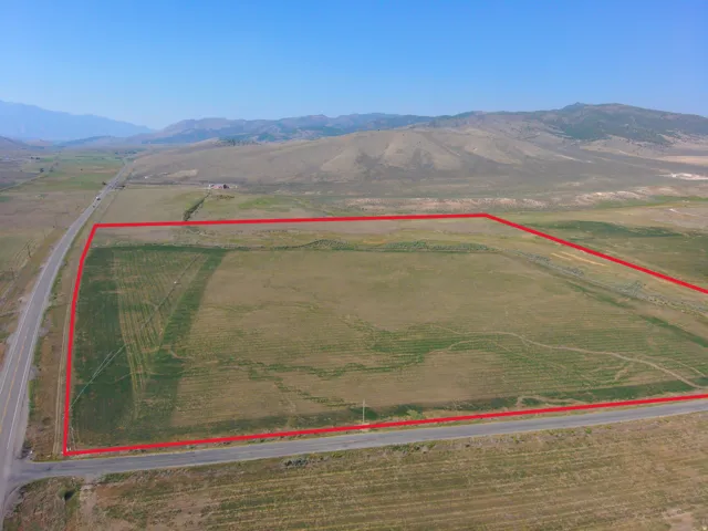 Expansive land parcel with surrounding mountains and clear skies