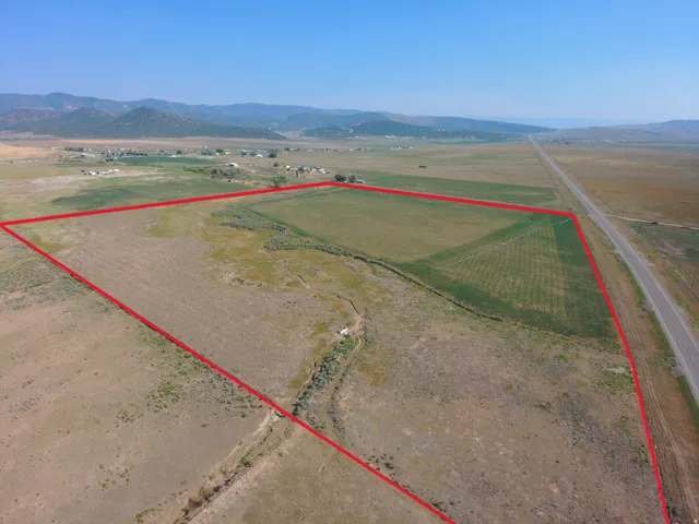 Expansive rural property with diverse terrain and distant mountain ranges