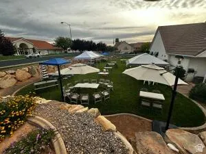 Expansive lawn area with a multi-level rock landscaping feature