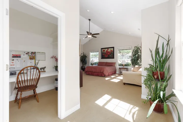 Vaulted ceiling with a ceiling fan, recessed lighting, and multiple windows
