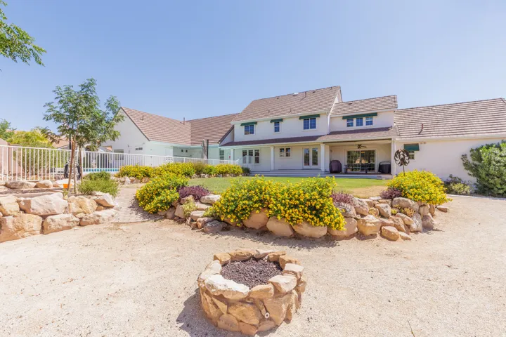 Elegant residence featuring a French Colonial architectural style with multi-level rooflines and dormer windows