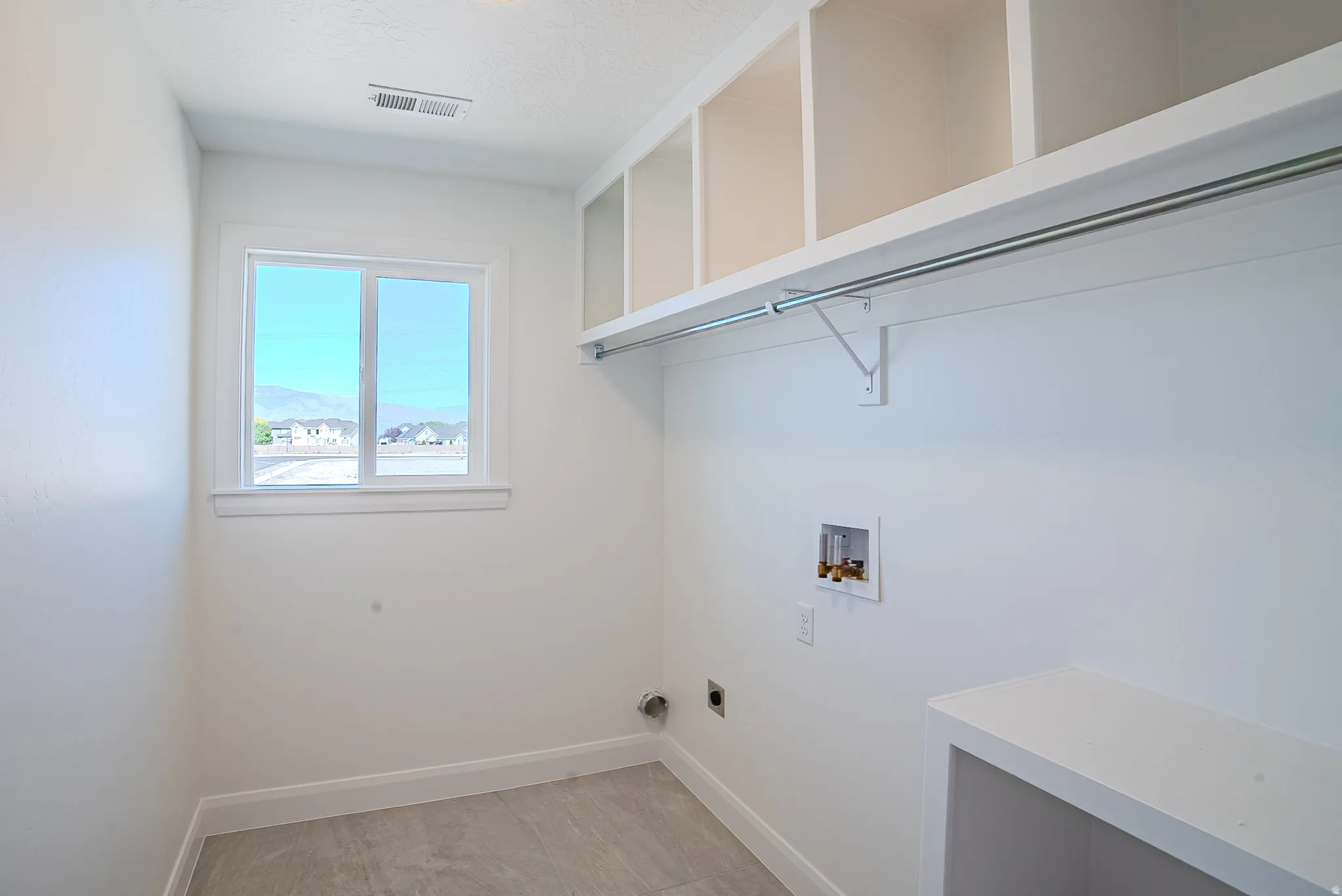 Built-in shelving, integrated hanging rod, and a window for natural light
