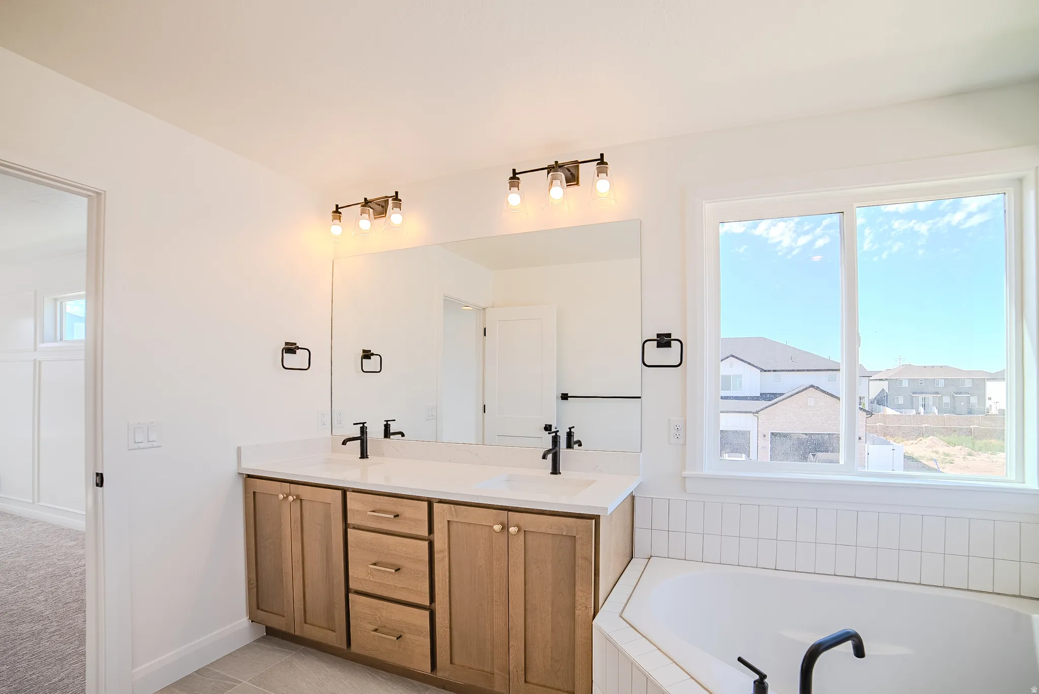 Dual vanity with wood-finish cabinetry and white countertops
