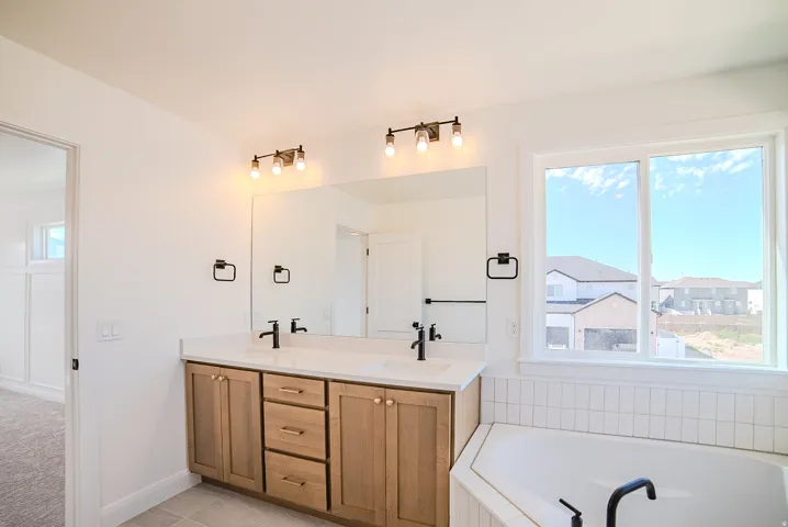 Dual vanity with wood-finish cabinetry and white countertops