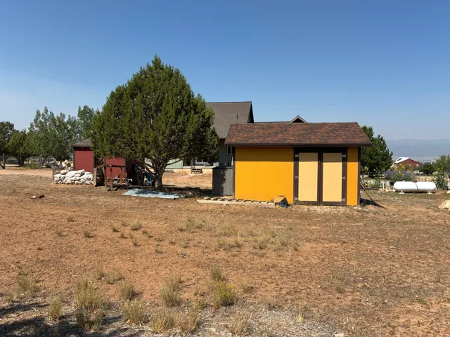 Two detached storage sheds with shingle roofing