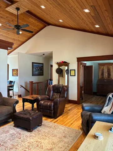 Vaulted wood-paneled ceiling with recessed lighting and a ceiling fan, wood-finish flooring, and wood trim throughout