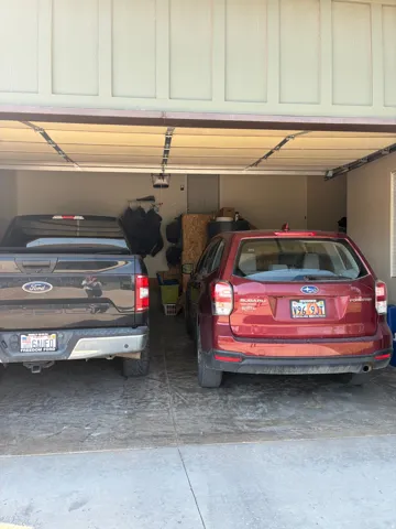 Garage with concrete flooring and light-colored walls