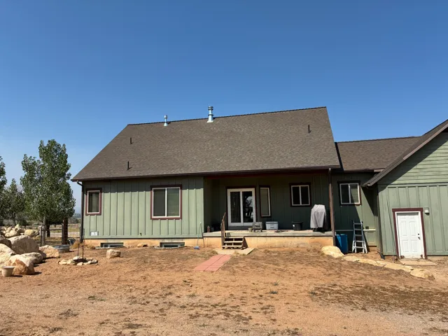 Green vertical siding exterior with contrasting trim